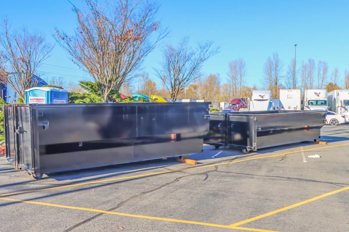 Professional dumpster rental service with roll-off container on residential driveway in Indian River Estates